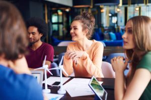 Young coworkers talking at conference table