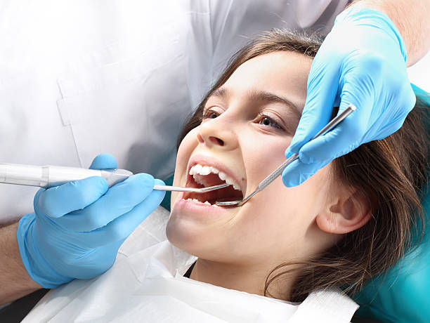 Child in the dental chair dental treatment during surgery.